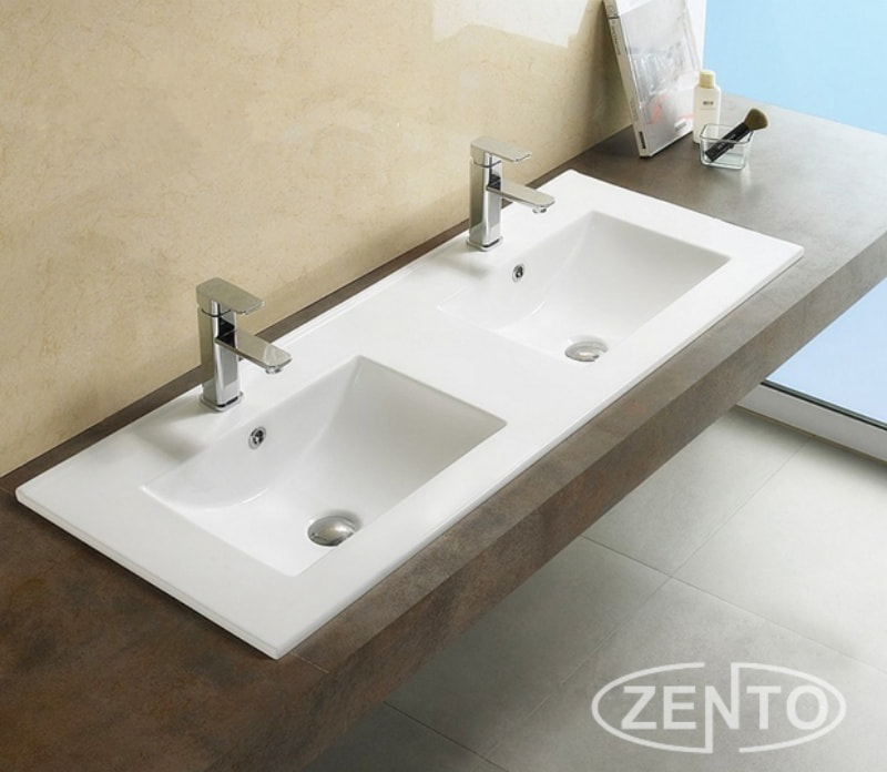 Lavabo bán âm bàn đôi Zento mang đường nét uyển chuyển, vành mỏng và trắng sáng giúp không gian phòng tắm thêm sang trọng và tinh tế.