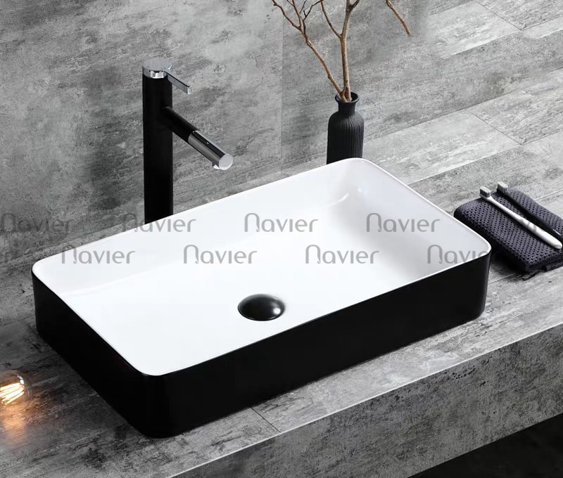 Mẫu chậu lavabo đặt bàn Navier NV-437TD có kiểu dáng hình chữ nhật đơn giản, tinh tế, màu sắc trắng đen tạo nên sự hiện đại và sang trọng cho phòng tắm.